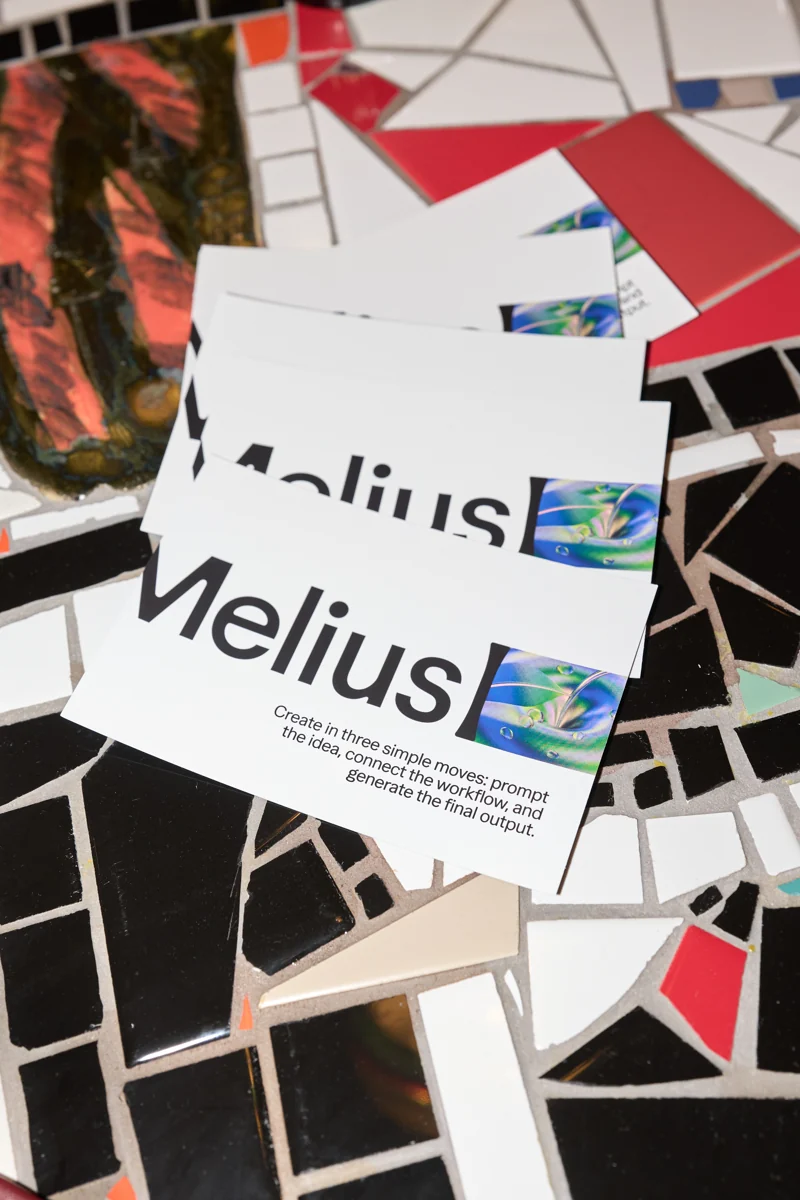 Melius post cards spread across a mosaic table at Opal Happy Hour