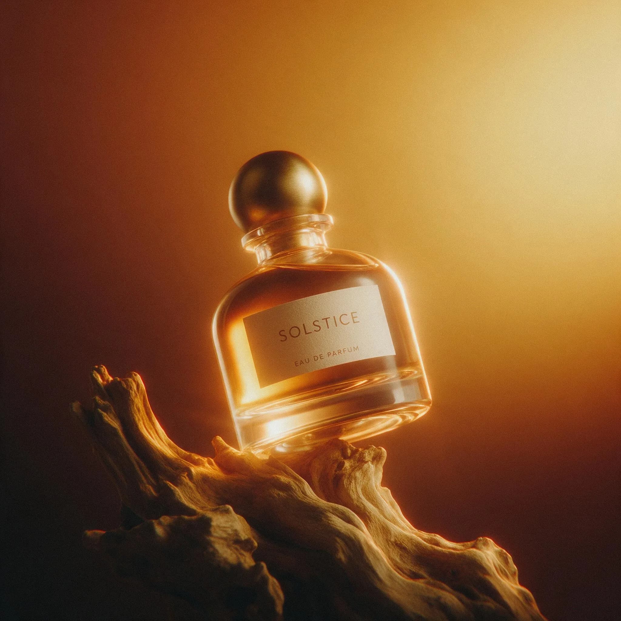 The SOLSTICE fragrance bottle on driftwood in warm desert light.