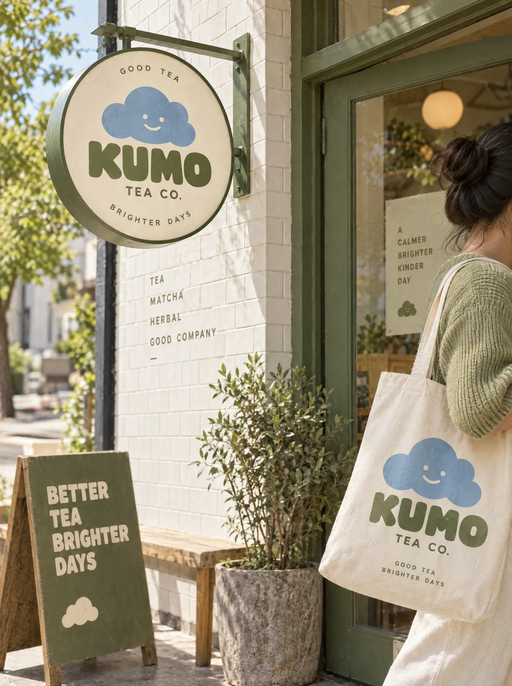 The KUMO Tea Co. storefront: a hanging cloud sign over a café window.