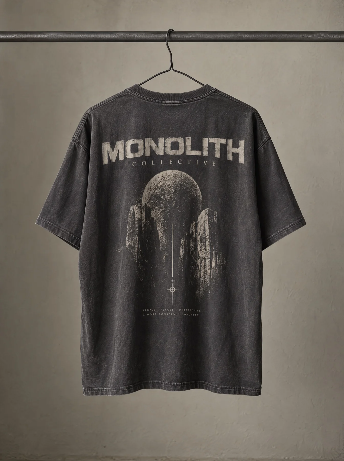 A washed Monolith Collective tee on a hanger