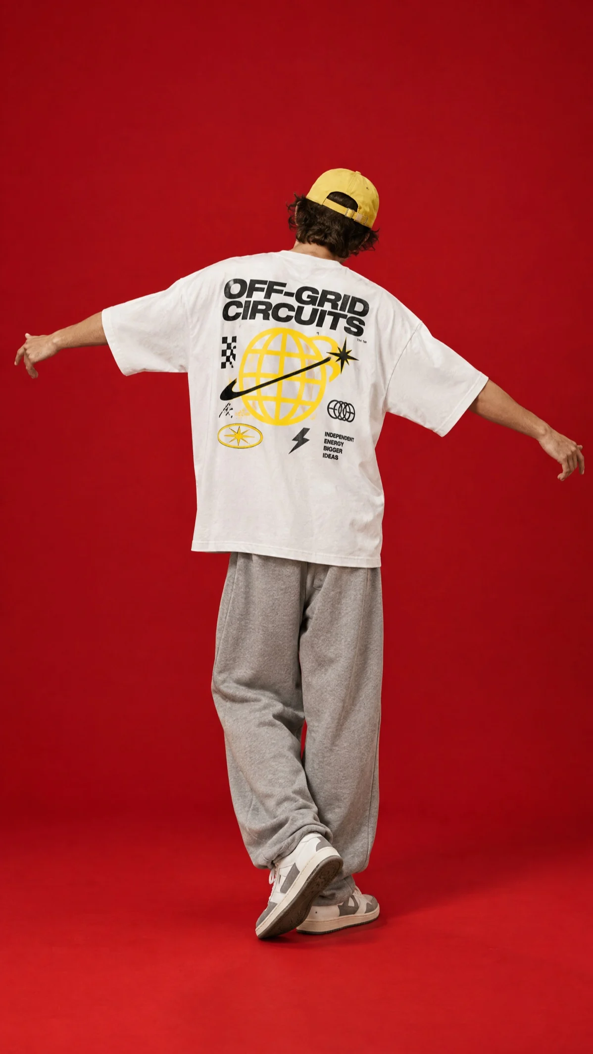 The back of an Off-Grid Circuits tee on red